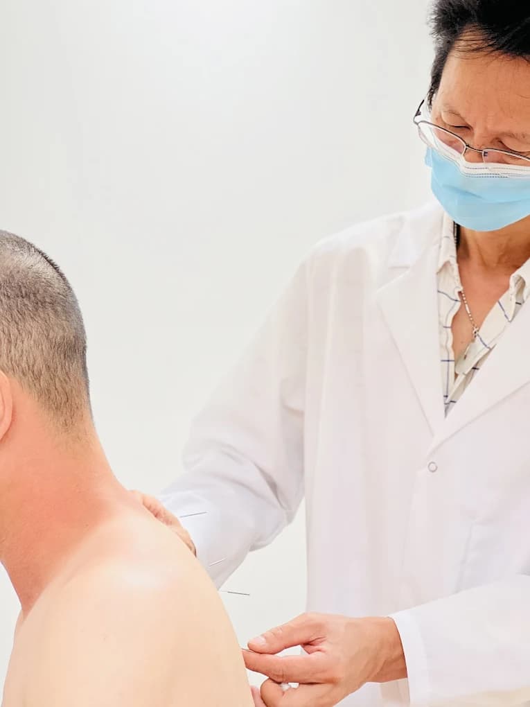 Clinician preparing a modern acupuncture treatment